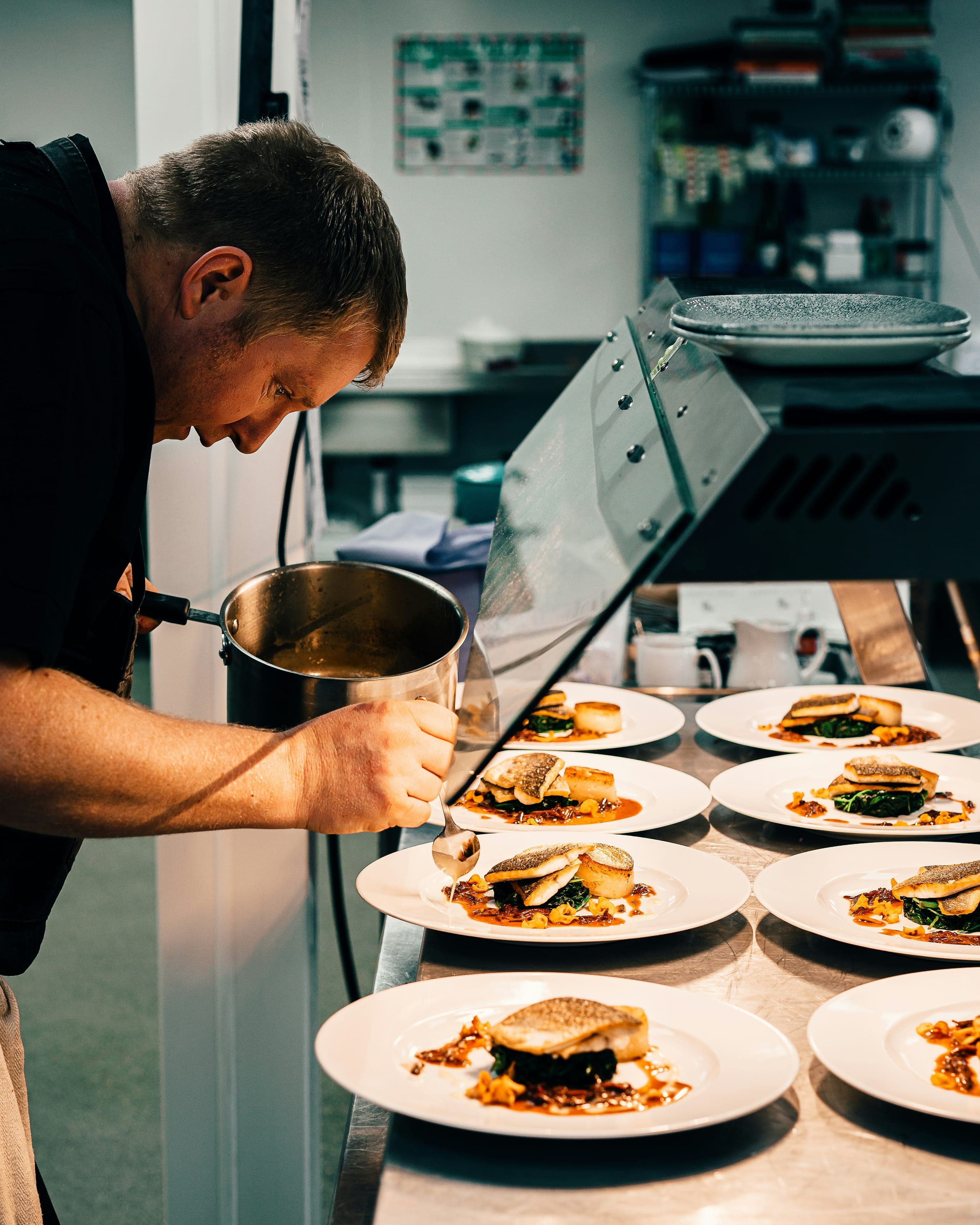 Chef preparing plates at Sanbay Fusion